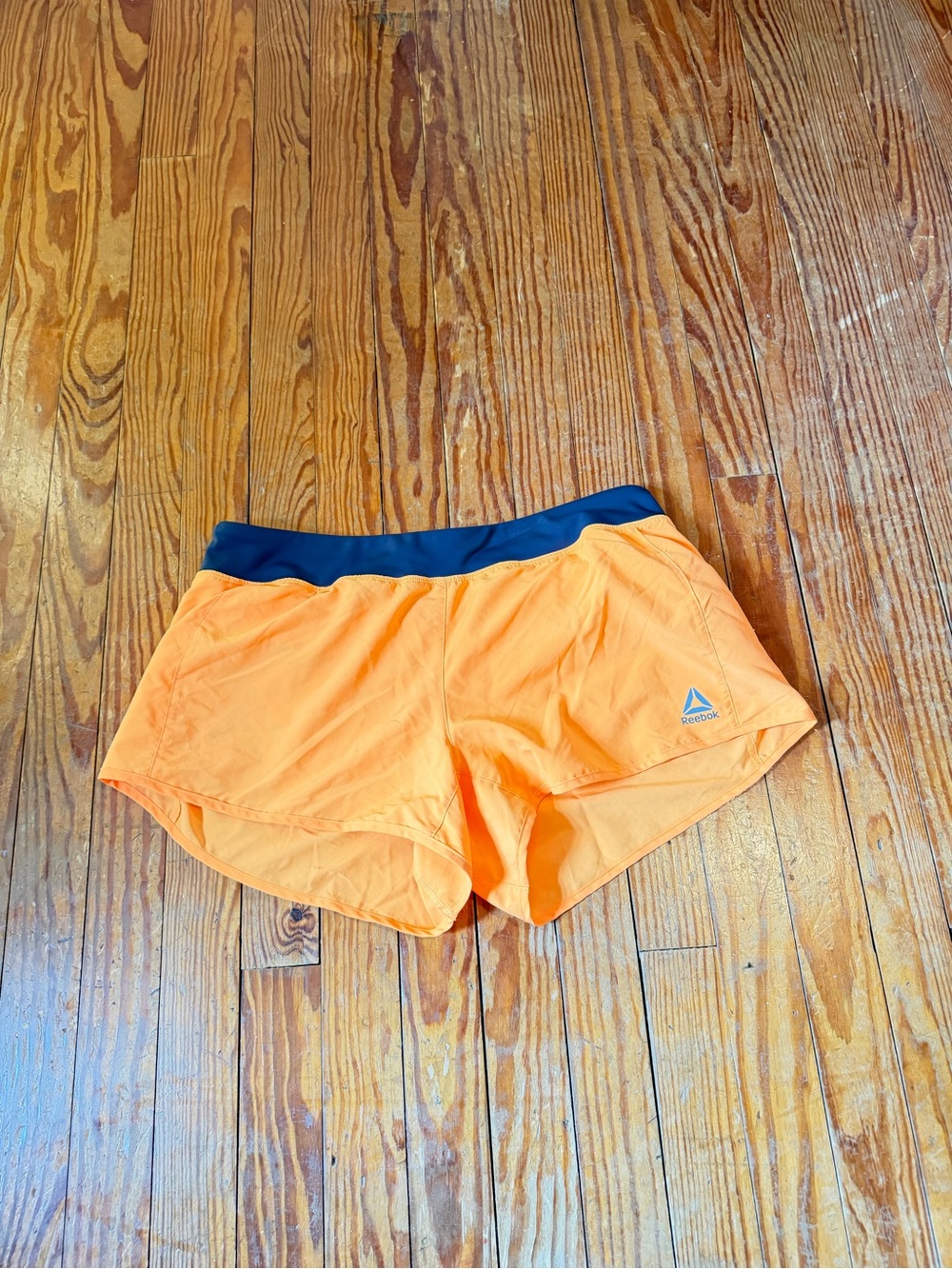 Les Mills Reebok Orange Performance Shorts with Navy Trim